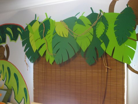 Window treatment with shades and leaves for jungle themed bedroom